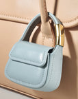 Blue leather mini purse charm attached to tote bag handle
