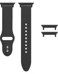 Black silicone Apple Watch® band unclasped, flat-lay view showing pin-and-tuck closure and size adapters