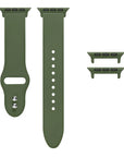 Olive green silicone Apple Watch® band unclasped, flat-lay view showing pin-and-tuck closure and size adapters