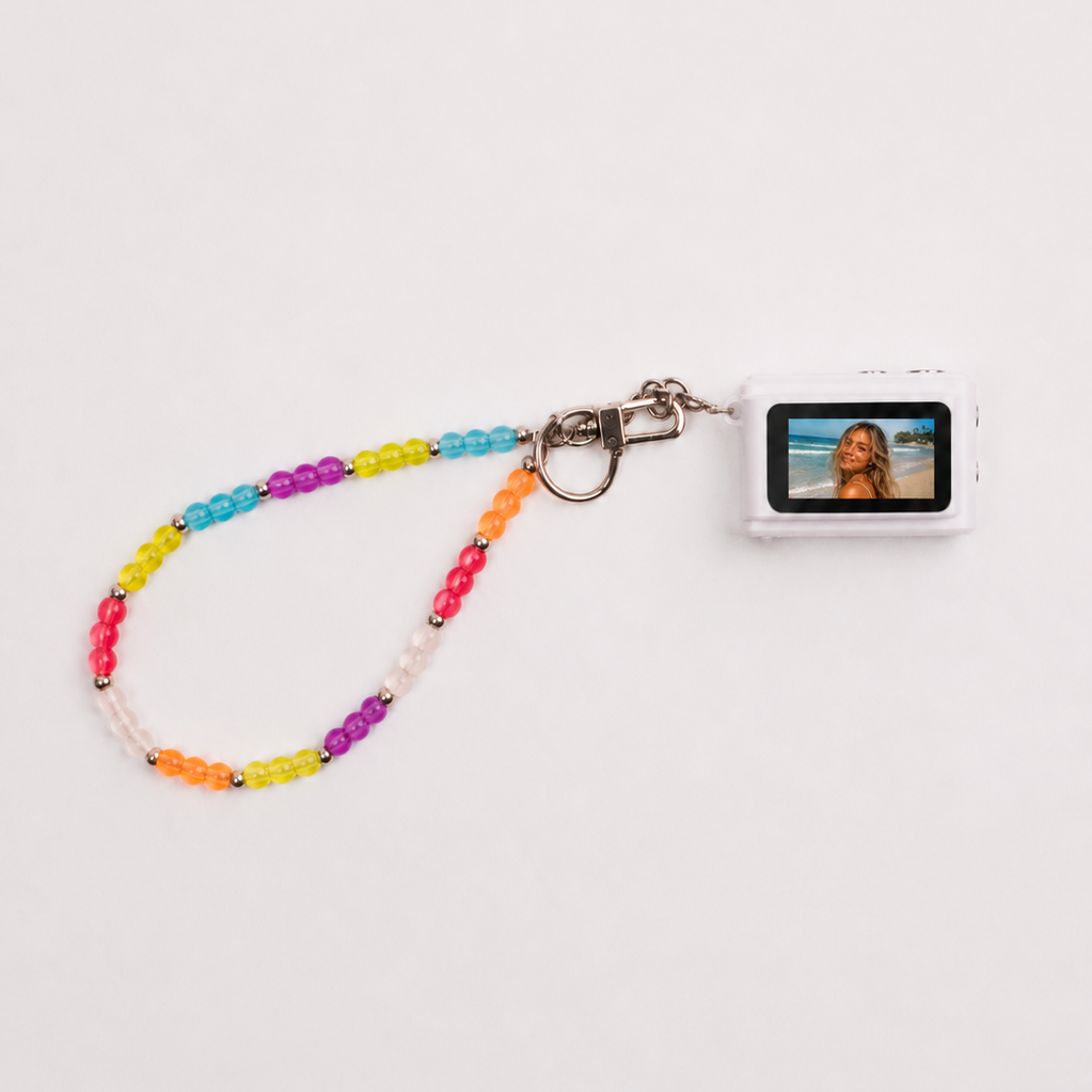 Mini digital camera with rainbow beaded lanyard showing photo on screen