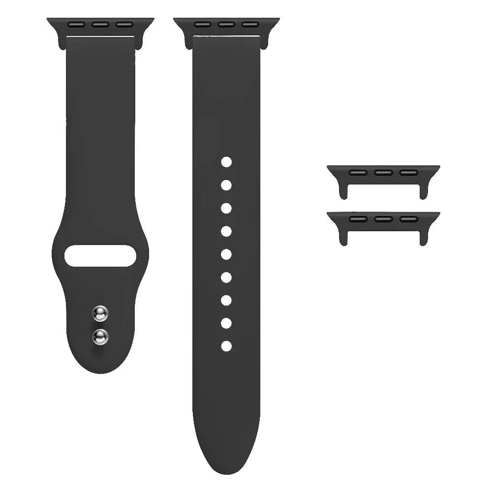 Black silicone Apple Watch® band unclasped, flat-lay view showing pin-and-tuck closure and size adapters