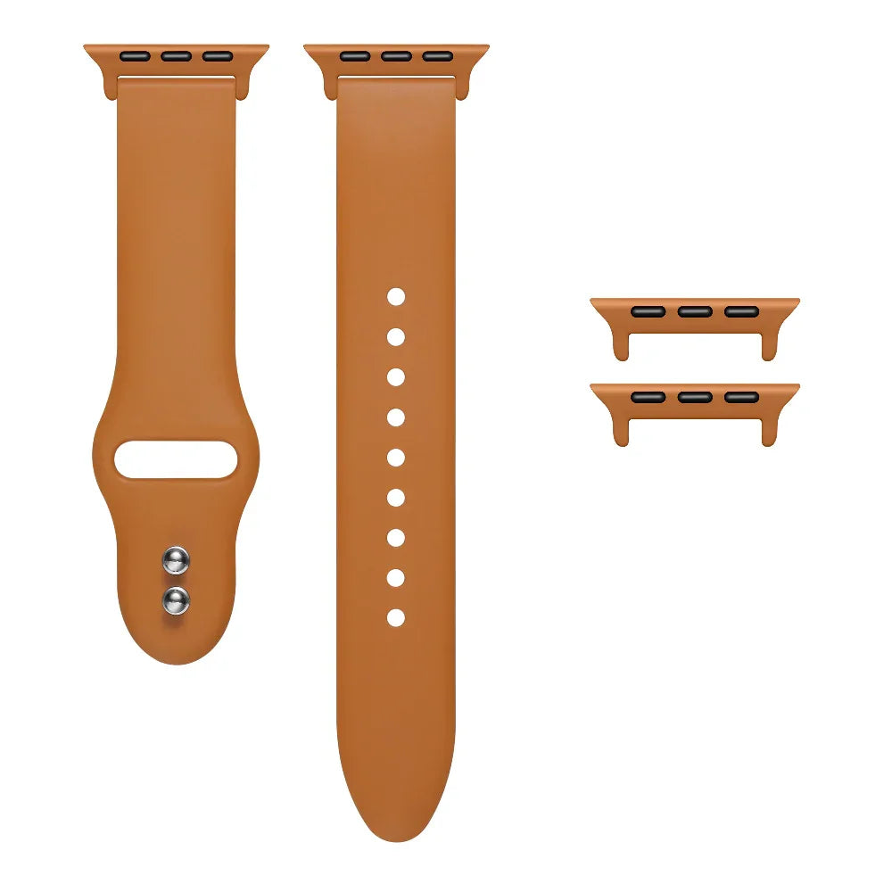 Rustic Caramel silicone Apple Watch® band unclasped, flat-lay view showing pin-and-tuck closure and size adapters