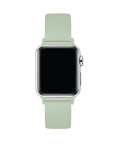 Sage green silicone Apple Watch® band fastened on the watch case, angled side view showing pin-and-tuck closure