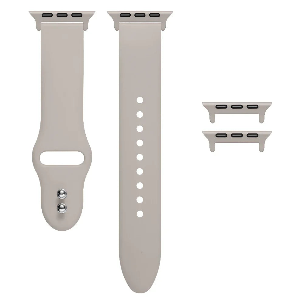 Starburst silicone Apple Watch® band unclasped, flat-lay view showing pin-and-tuck closure and size adapters