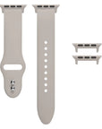 Starburst silicone Apple Watch® band unclasped, flat-lay view showing pin-and-tuck closure and size adapters